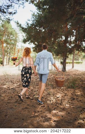Happiness and love are in the air. Woman and man in the forest. Outdoors concept.
