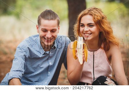 Close-up portrait photo of happy people on a bright picnic, sitting in the forest. Lifestyle concept.