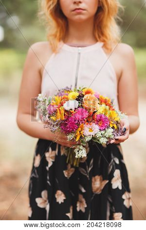 Close-up photo of body parts pretty girl. with bright gift, standing in the forest. Lifestyle concept.
