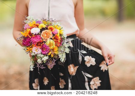 Close-up photo of body parts pretty girl. with bright gift, standing in the forest. Lifestyle concept.