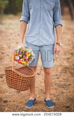 Close-up photo of body parts cute boy. with bright gift, standing in the forest. Lifestyle concept.