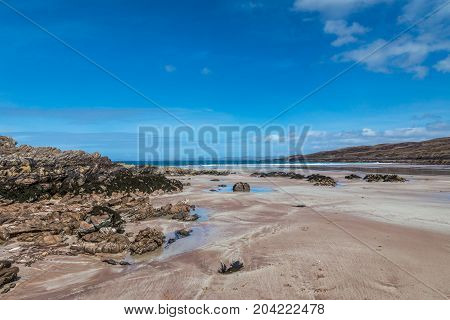 Achnahaird Bay Beach, sand  and rocks on a beautiful day.