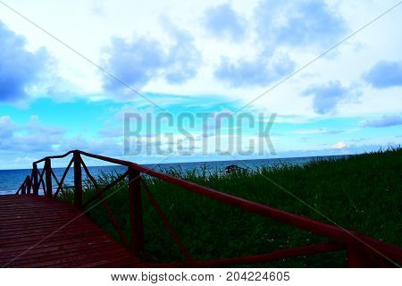 picture took of a bridge ,from the street to the beach