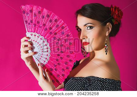 Flamenco Carmen Beautiful Woman In Black Dress With A Red Rose In Her Hair On Dark Background. Argen