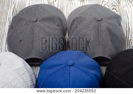 Snapback hats on white wooden background isolation