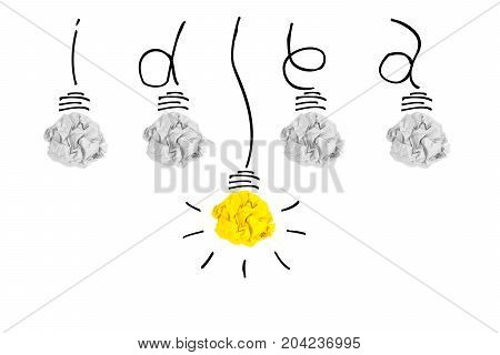 Creative concept. Yellow light bulb outstanding on bulb crumpled paper and wires that wrapped be word idea on white background