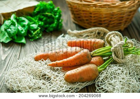 Bunch Of Fresh Organic Dirty Carrots And Oher Purchased Products From Farm Market On The Wooden Back