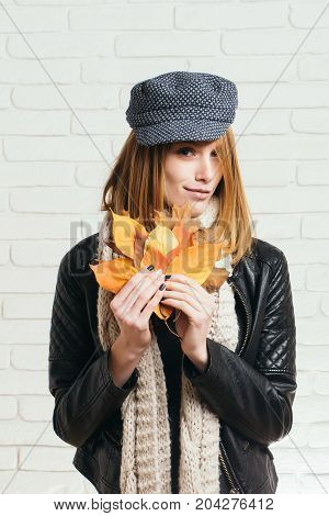 Woman With Autumn Leaves In Leather Jacket.