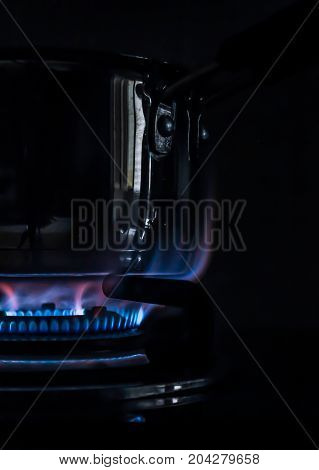 blue flames of stove while cooking in the kitchen