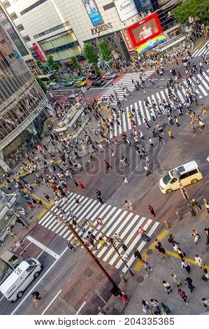 TOKYO, JAPAN JUNE 28 - 2017: Top view of crowd of people crossing in Shibuya street, one of the busiest crosswalks in the world, in the Ginza District in Tokyo, Japan.