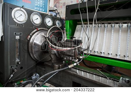 close-up high pressure diesel fuel pump test bench on work