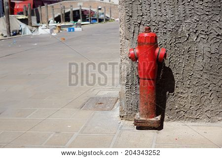 Old red fire hydrant in the street. Fire hidrant for emergency fire access .