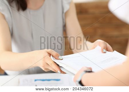 Female Employee Show Pack Of Documents To Manager