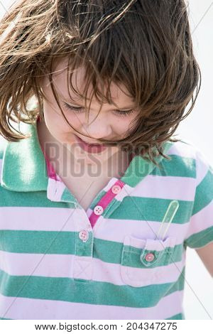 View of Young little girl on beach playing in the surf