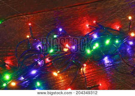 Christmas rustic background - vintage planked wood with lights and free text space.