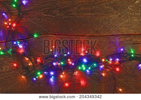 Christmas rustic background - vintage planked wood with lights and free text space.