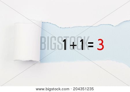 1+1=3 written under torn white paper. Business, technology, internet concept.