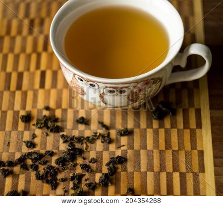 The cup of green tea on wooden table