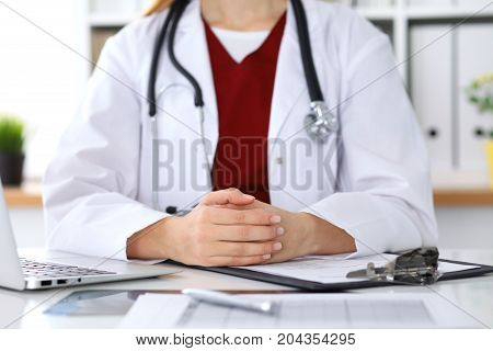 Close up of a unknown female doctor's hands. Physician is ready to consult and halp patients. Medicine and health care concept