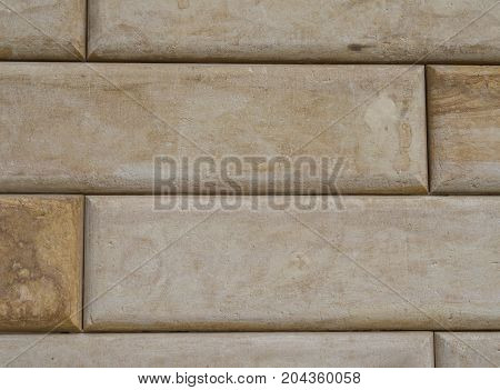 polished sandstone beige brick wall facade background