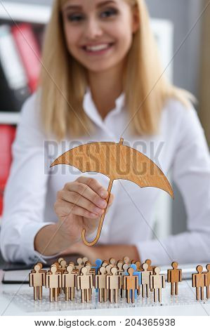 Smiling Business Woman In Hand Holds A Miniature Umbrella In The Hand