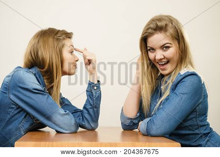 Woman Mocking Her Confident Friend