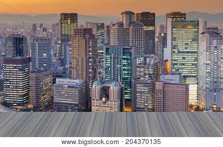 Opening wooden floor Osaka central business downtown with sunset sky background Japan