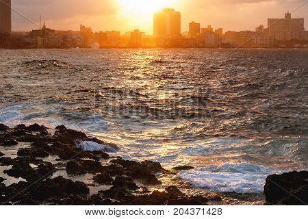 Sunset after storm at famous embankment promenade Malecon. Havana Cuba.