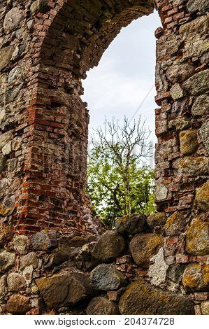 very old Kazdangas church wall of stones.