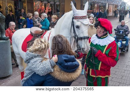 The Hague the Netherlands - 26 November 2016: chimney pete in crowd with the horse of Sinterklaas