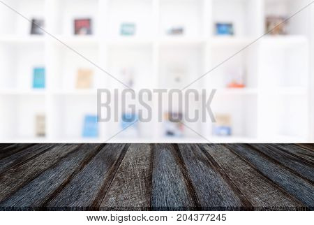 Empty wooden table and blur background of abstract in front of modern library or knowledge source can be used Mock up for display of product or for montage.