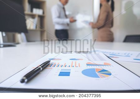 Business people conference Two confident executive colleagues meeting and discussing working in business strategy and financial plan to investment profit on graph and chart.