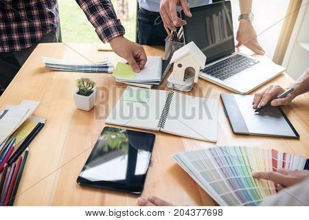 Young colleagues designers working together on a creative project and color samples for selection Color swatch samples Brainstorming Planning Partnership creative graphic design working desktop.