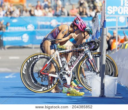 STOCKHOLM - AUG 26 2017: Female triathletes Taylor Spivey (USA) and competitors taking of helmets in the transition zone in the Women's ITU World Triathlon series event August 26 2017 in Stockholm Sweden