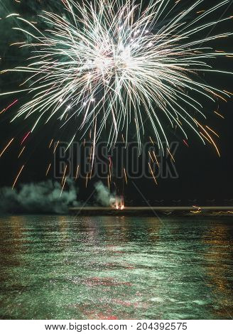 MARINA DI MASSA, ITALY - AUGUST 22 2015: Firework by the sea in Marina di Massa Italy from its famous pier