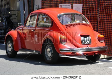 LASTRA A SIGNA, ITALY - AUGUST 30 2015: Vintage red beetle parked on the street in Lastra a Signa Florence