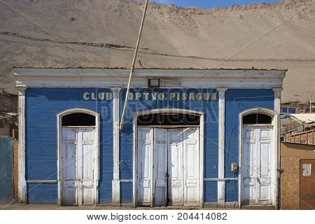 Pisagua, Tarapaca Region, Chile - August 21, 2017: Historic wooden buildings from the era of nitrate mining in the Atacama Desert, in the coastal town of Pisagua in northern Chile.