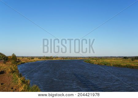 The Limpopo River in flat land of Mozambique the coasts are red and dry the sky clean and blue