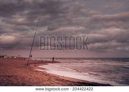 Sunset over Castelldefels beach in summer with clouds