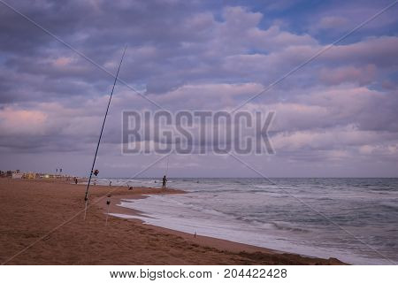 Sunset over Castelldefels beach in summer with clouds