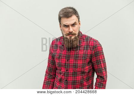 Handsome Businessman With Beard And Handlebar Mustache Looking At Camera With Angry Face