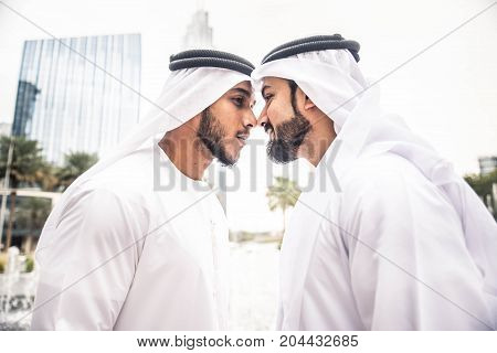 Arabic businessmen in Dubai greeting with traditional gesture