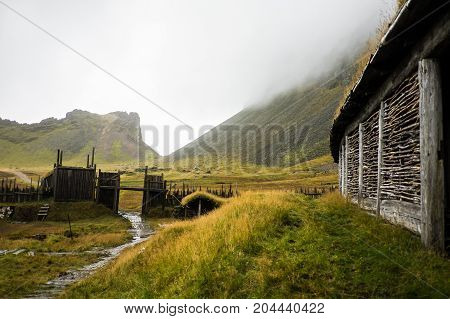 Traditional icelandic viking skyfall village. Wooden houses near mountains. Skyfall.