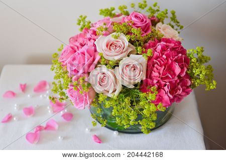 Close-up floral composition with a pink roses .Many beautiful fresh pink roses on a table.