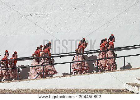Ronda, Spain - May 3, 2014: Children dancers going to the stage during Corpus Christi Procession festival in Ronda, Spain