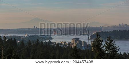 Morning view of Vancouver and Burnaby British Columbia Canada city skyline with Lions Gate Bridge and Stanley park Panorama