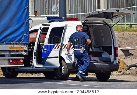 Police man and police car at the scene of a traffic accident