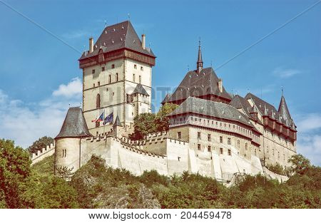Karlstejn is a large gothic castle founded 1348 by Charles IV in Czech republic. Ancient architecture. Retro photo filter.