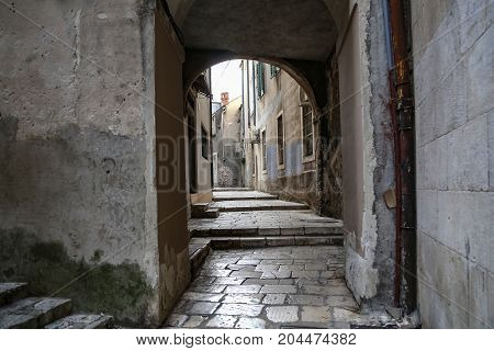 Tourist city by the Adratic sea - Sibenik, Croatia. The old stones, narrow street and stairs.