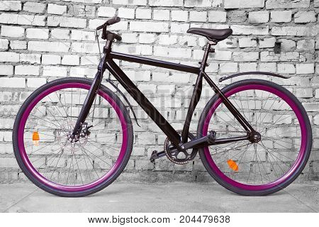 Black Fixed Urban Bike Against Black And White Brick Wall